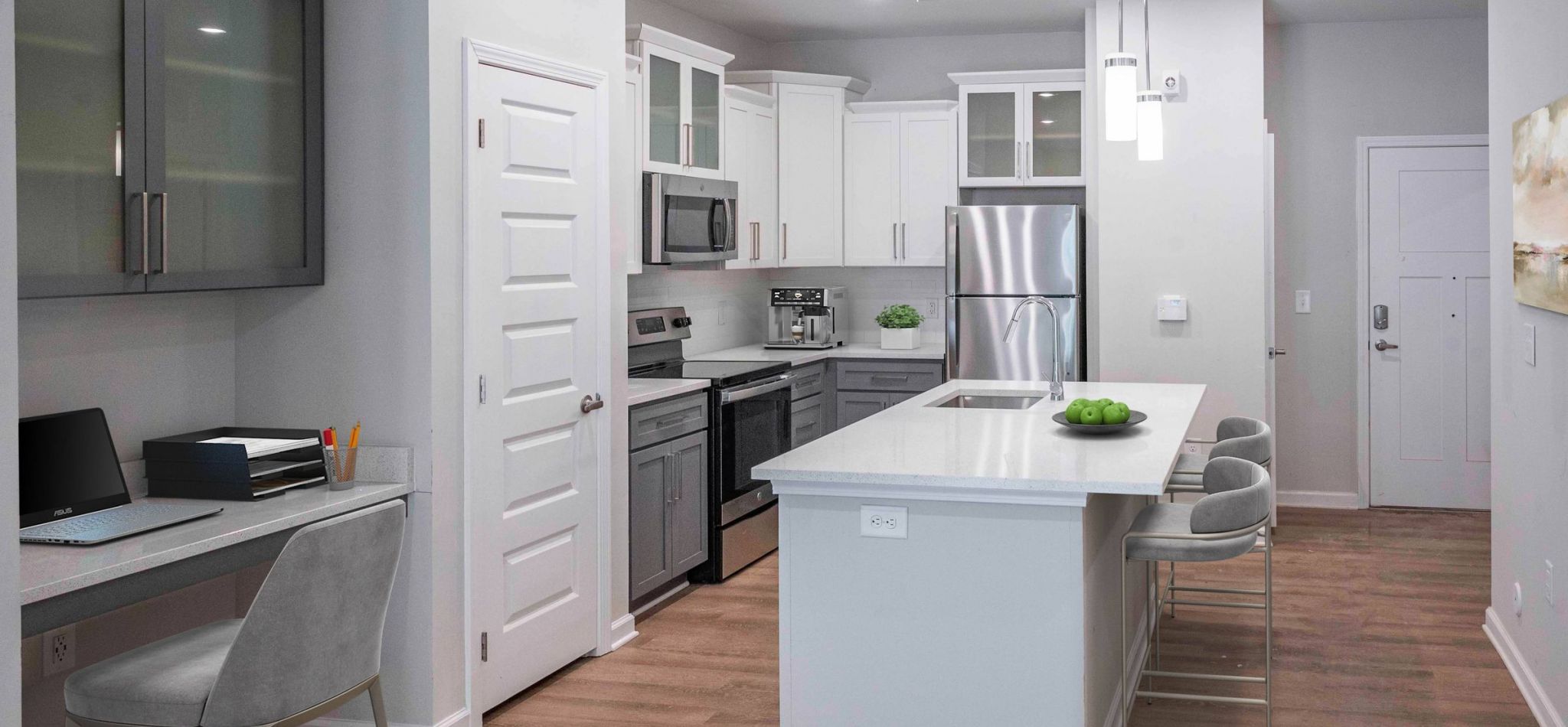Hawthorne Waterside sleek kitchen workspace with grey cabinetry, built-in desk, and a minimalist, modern design.